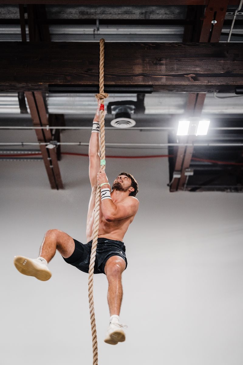 Cameron climbing a rope in training